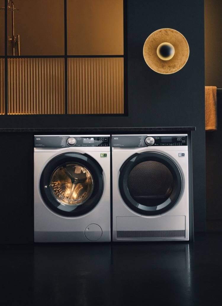 Woman sitting on washing machine