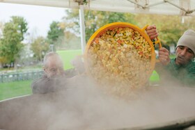 Cooking in a large pot at Feedback's Feed the 5000 event