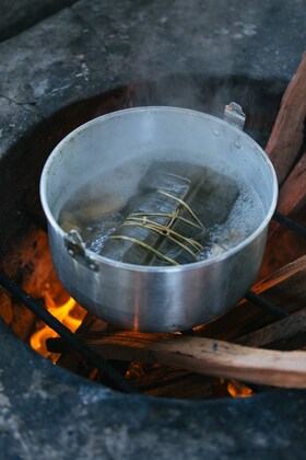 A pan of boiling water on a wood fire