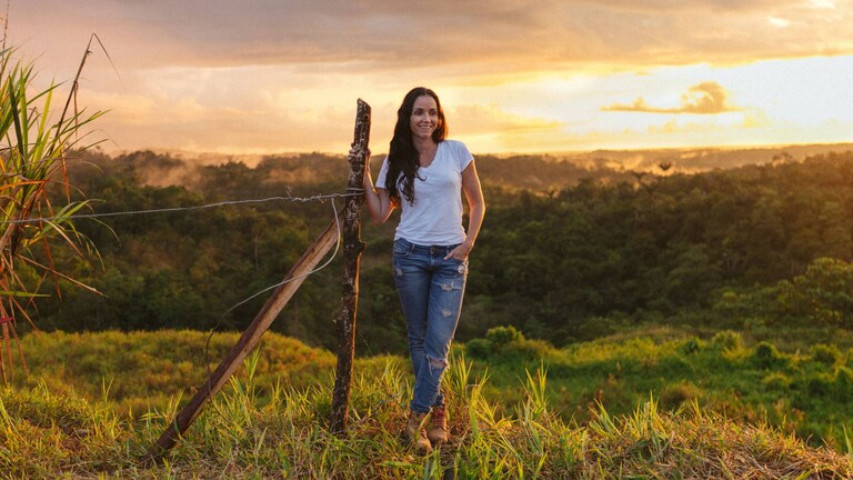Catalina Vélez standing in a sunny field at sunset