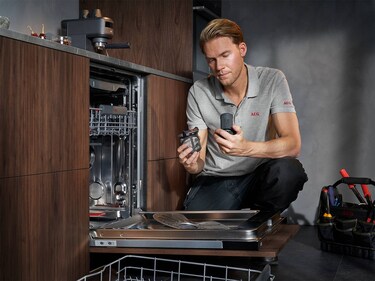Service technician repairing washing machine